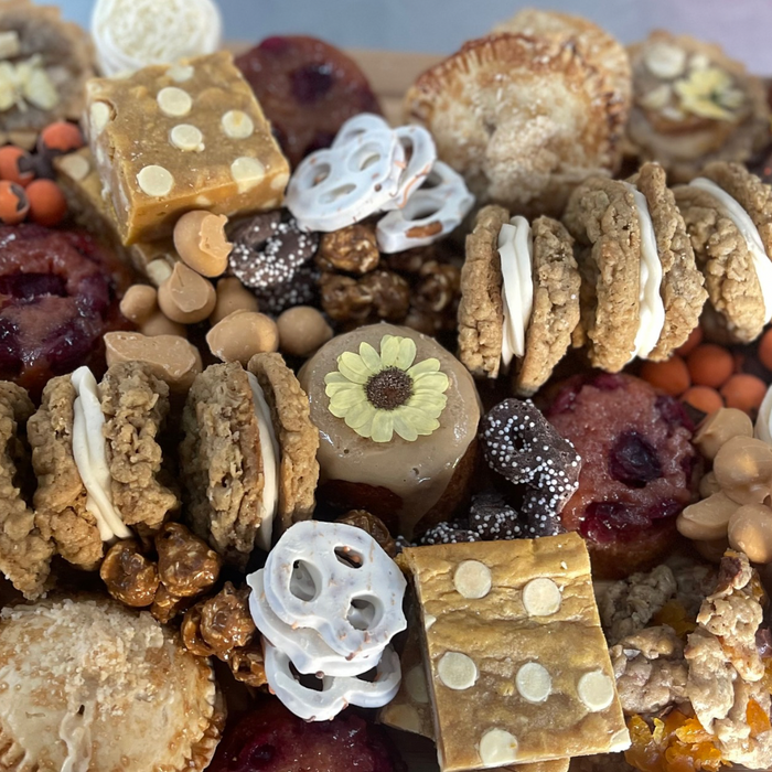 Thanksgiving Treat Feast dessert board with assorted seasonal cookies, tarts, bars, and sweets for large groups