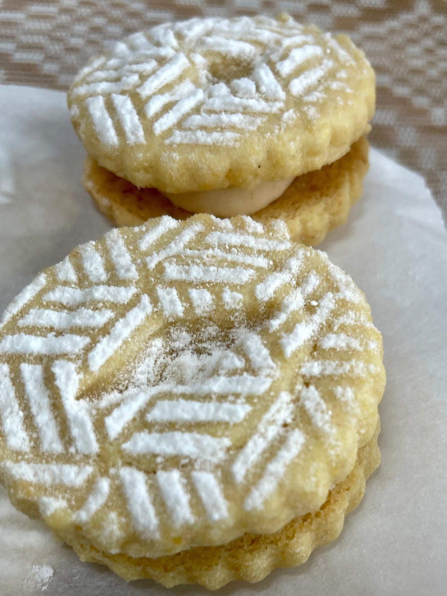 Corn Linzer sandwich cookies with brown butter honey filling displayed in a box of six