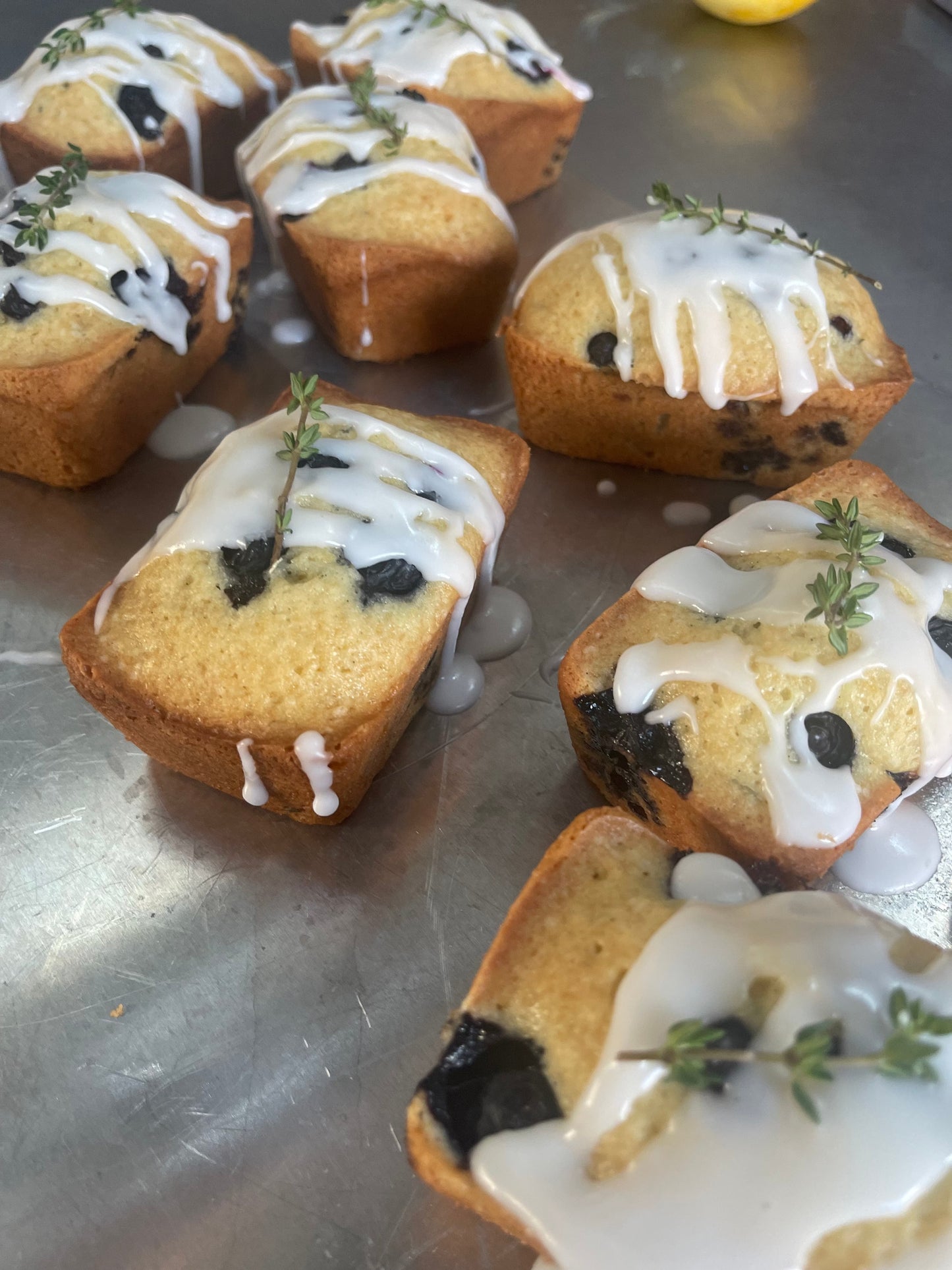 Blueberry Lemon Thyme Olive Oil Teacake with lemon drizzle and fresh thyme slices