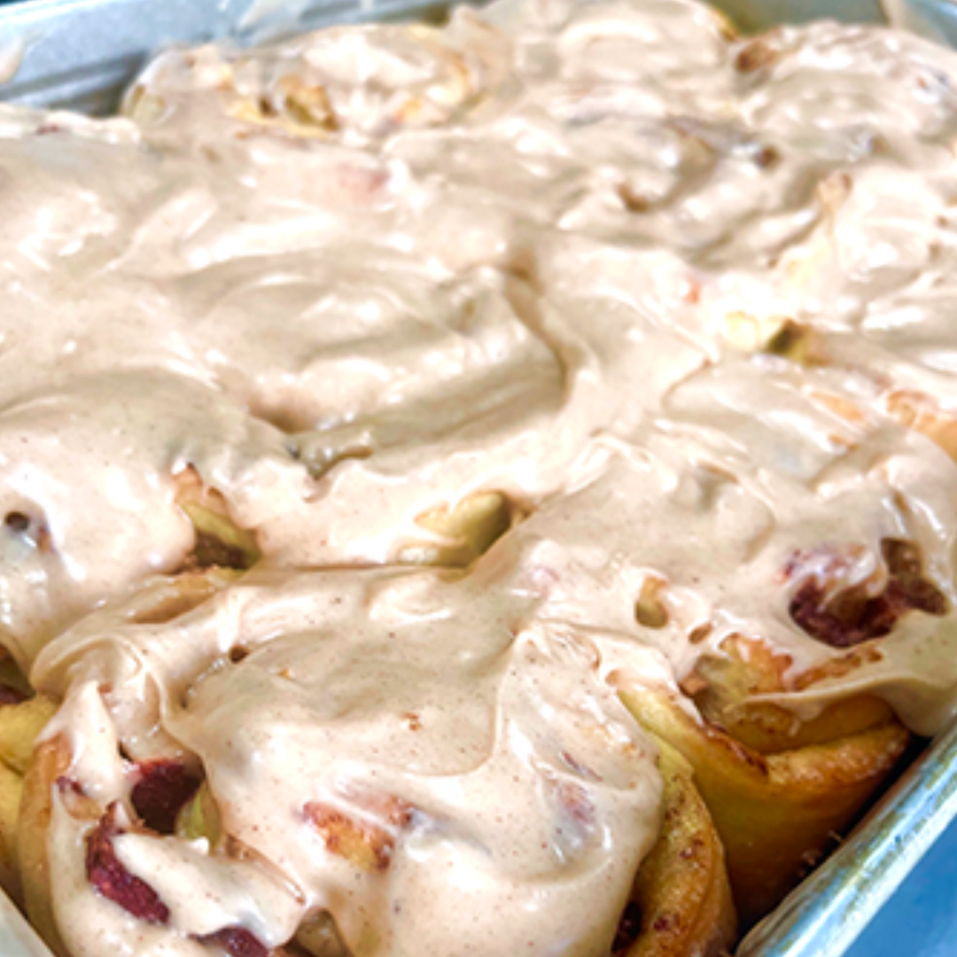Box of 4 orange cardamom cinnamon buns with citrus glaze and orange zest