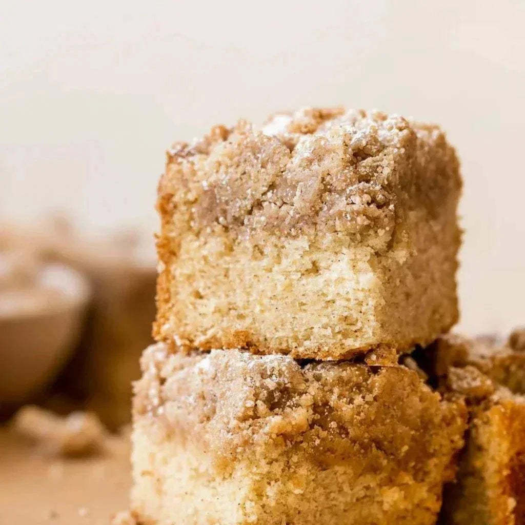 Four pieces of classic cinnamon coffee cake with spiced crumb topping in a box