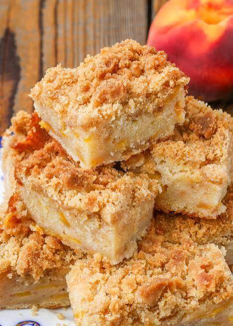 Peach coffee cake with streusel topping and pecans on a plate