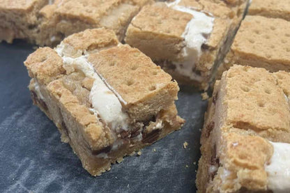 S’mores cookie bar with graham cracker crust, marshmallow, and chocolate layers topped with crumb dough and graham squares