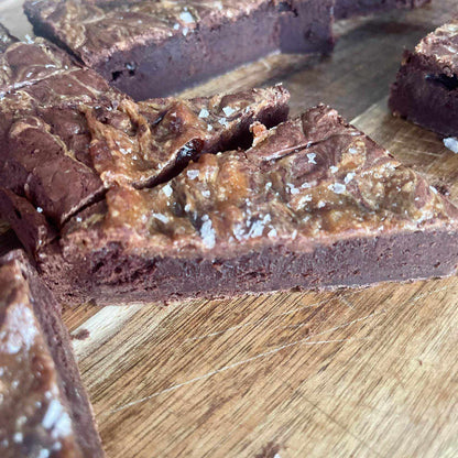 Flourless Dulce de Leche Swirl Brownie with caramelized milk swirl and flaky salt topping in a box of eight pieces
