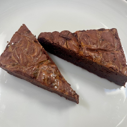 Flourless Dulce de Leche Swirl Brownie with caramel swirls and flaky salt topping in a box of eight pieces