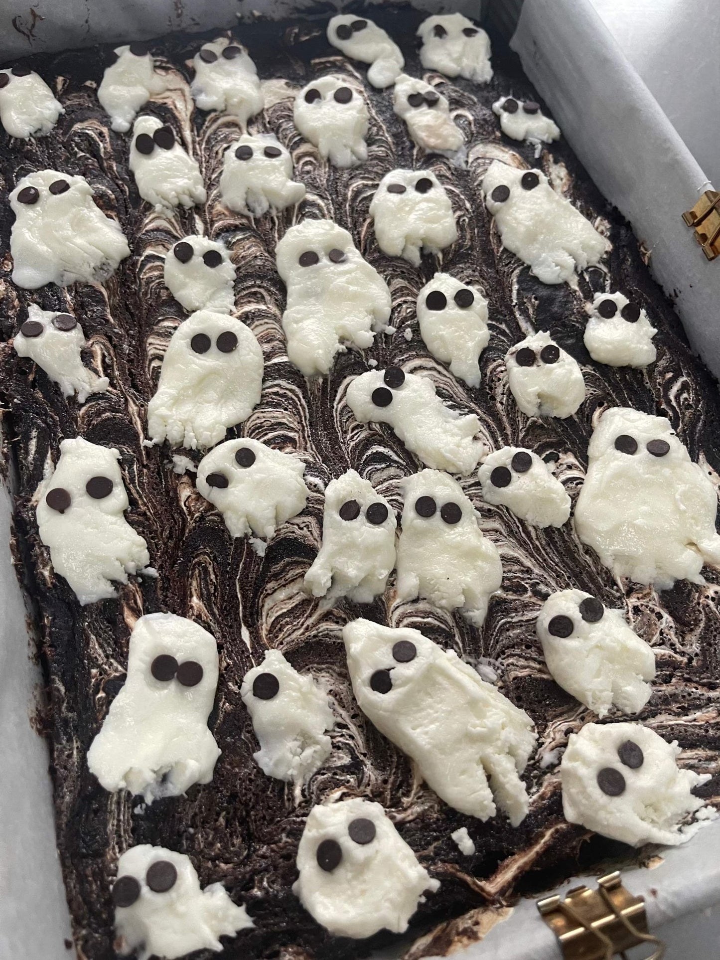 Spooky marshmallow swirl brownie with gooey texture and white swirl on top