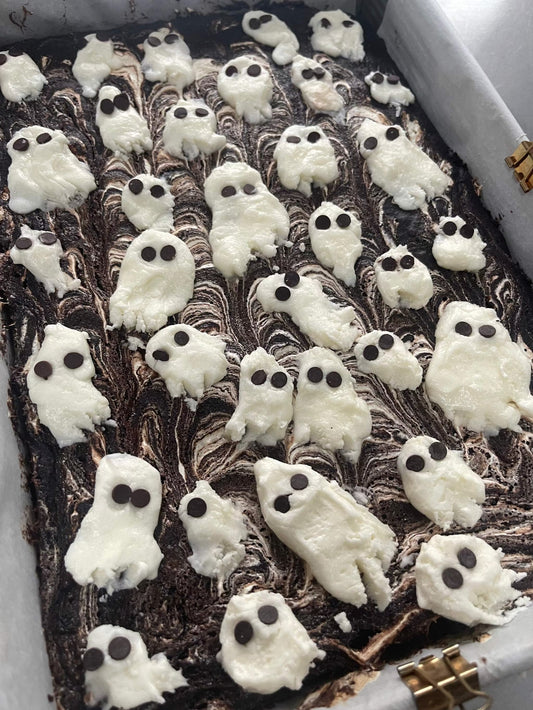 Spooky marshmallow swirl brownie with gooey texture and white swirl on top