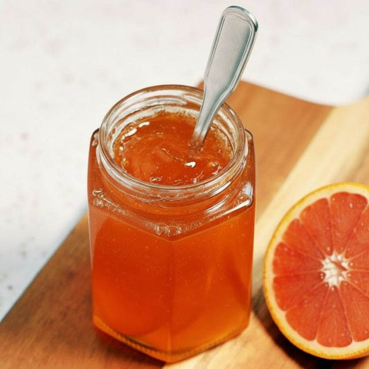 Jar of Cara Cara Cardamom Jam with citrus and cardamom ingredients