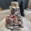 Holiday Treat Bundle featuring festive brownie tower, gingerbread, and candy canes with powdered sugar decoration
