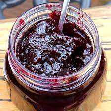 Jar of blueberry raspberry jam made with fresh cherries and berries